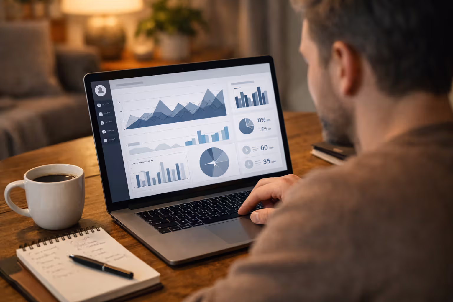 Person setting up an online loan servicer account on a laptop at a home desk with coffee and notepad