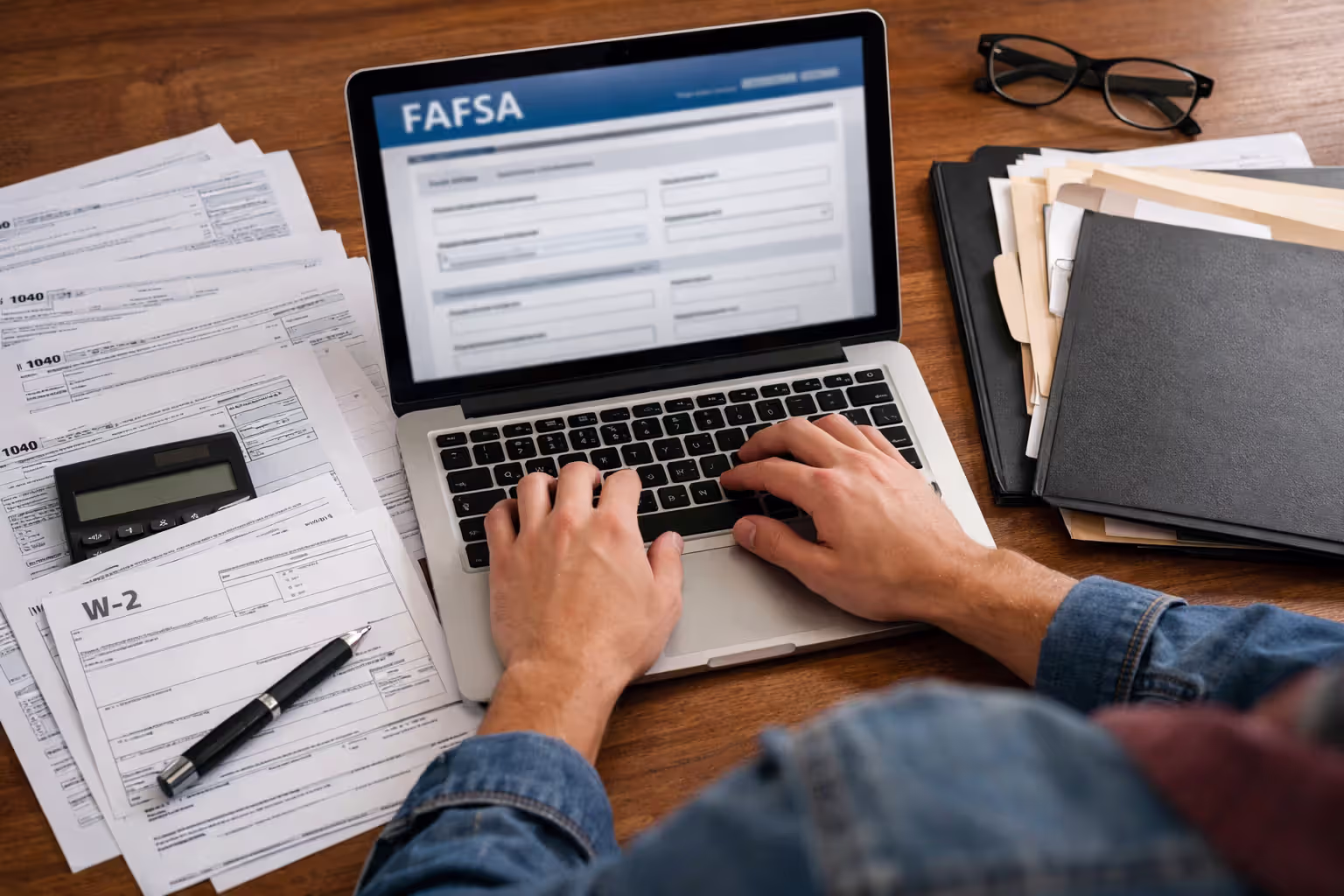 Student completing FAFSA with financial documents